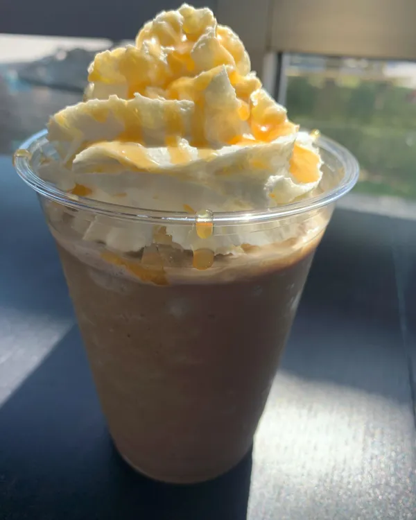 A caramel Blender frozen coffee drink topped with whipped cream