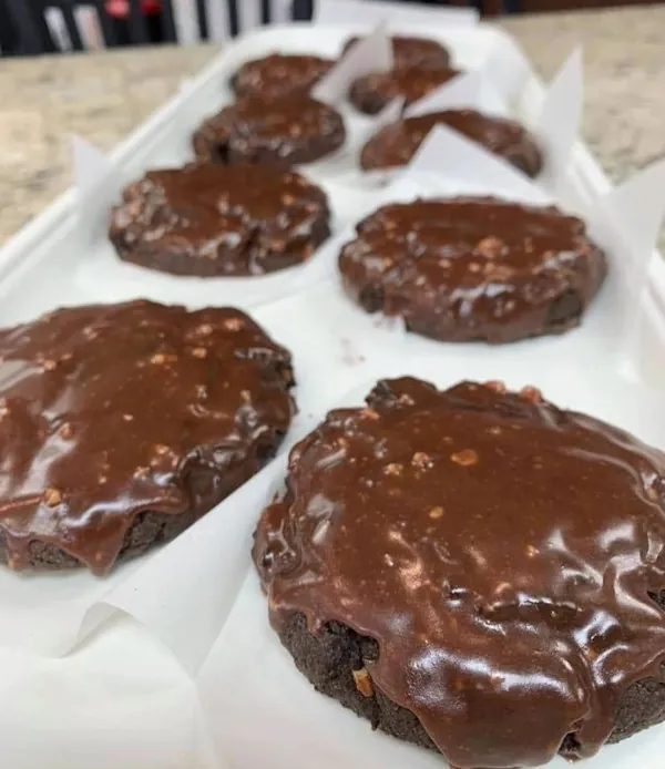 Chocolate iced cookies on parchment