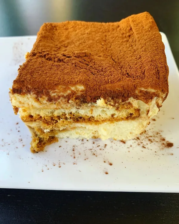 A square of tiramisu dusted with cocoa
